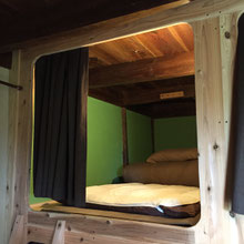 Capsule bed with pillow, blanket, mattress and a plug socket.