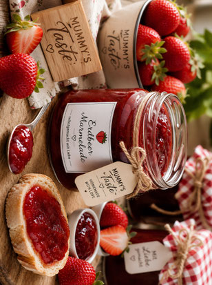 Hausgemachte Erdbeermarmelade im Glas mit frischen Erdbeeren