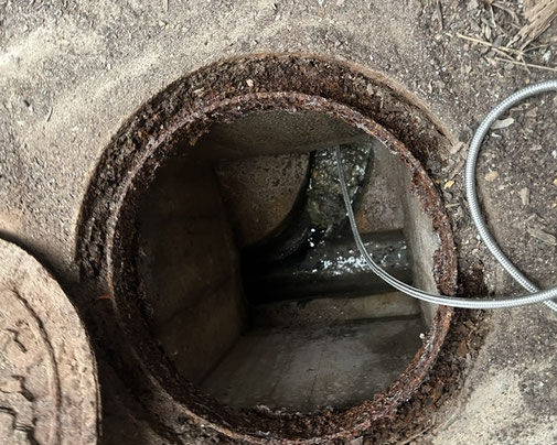 主管上にある桝の作業前写真。トイレ側の桝とつながる埋設管で詰まりが発生している状態。