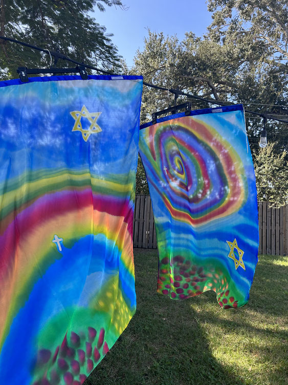 Silk Flags with rainbow colors, Star of David, swirling designs and a cross