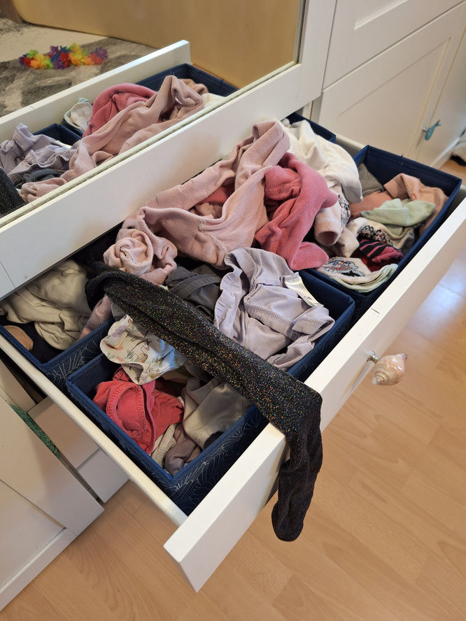 Überquellende Schublade mit Wäsche