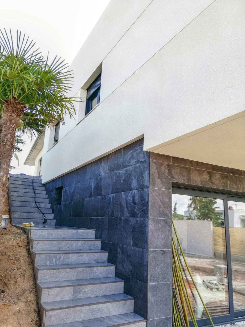 Combinación negro, gris (porcelanico antideslizante 90X45) con fachada de monocapa color marfil. #Elche