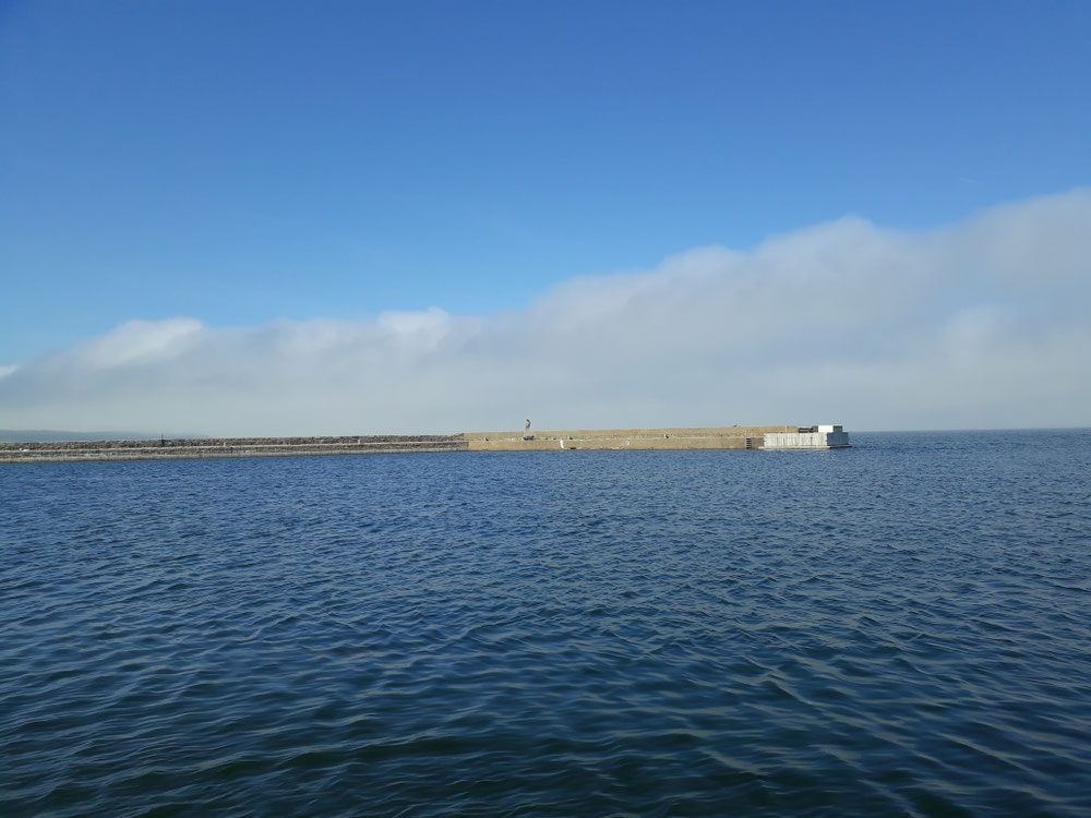 Fog clouds in the distance at Kivik harbor