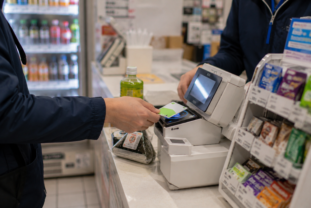 IC card being used at a Japanese vending machine by a foreign traveler