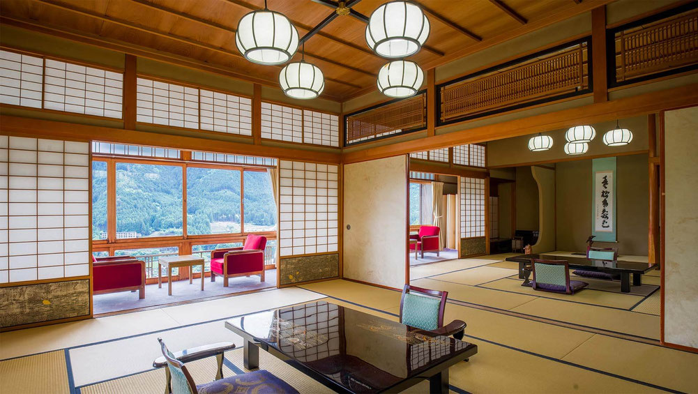 Traditional Japanese ryokan room in Gero Onsen with tatami, low table, and warm natural light.