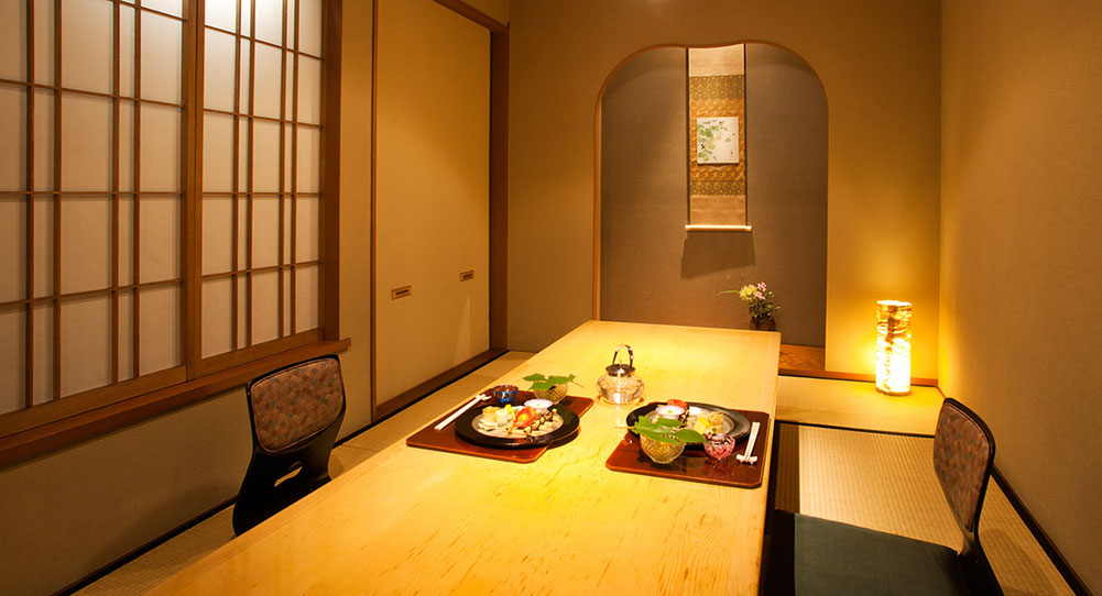 Traditional Japanese ryokan dinner setting with kaiseki-style dishes on a low table.