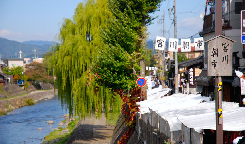 Riverside stalls at Miyagawa Morning Market in Takayama with local produce and crafts.
