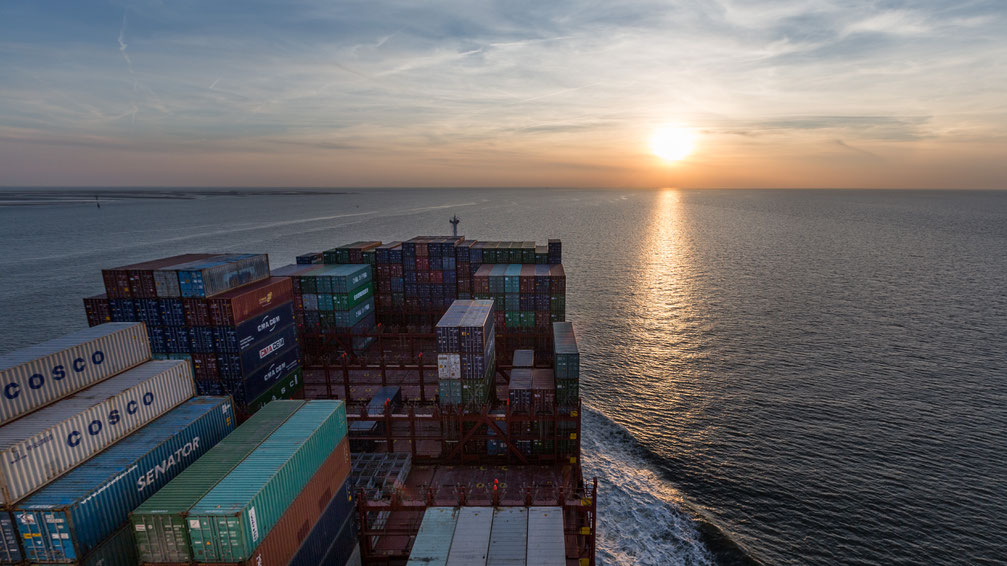 On a container ship in the North Sea towards the sunset