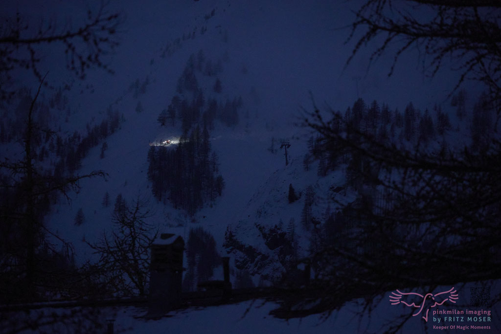 A "snow groomer" piste basher" at work in the night