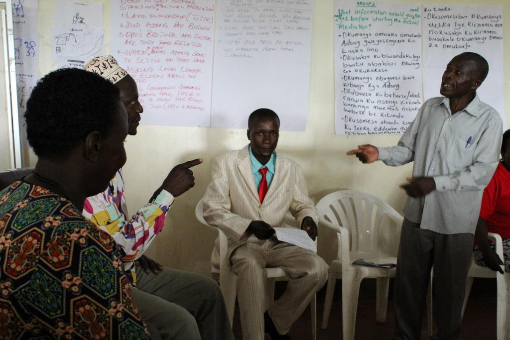 Participants in a role play on land conflict mediation during a training in Mubende district.