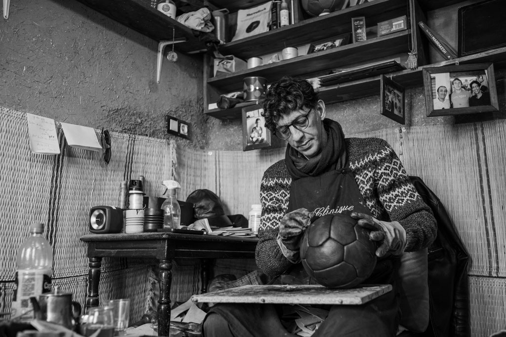Kamal Boukentar handcrafting a football ball at La clinique du ballon - Marrakech Morocco