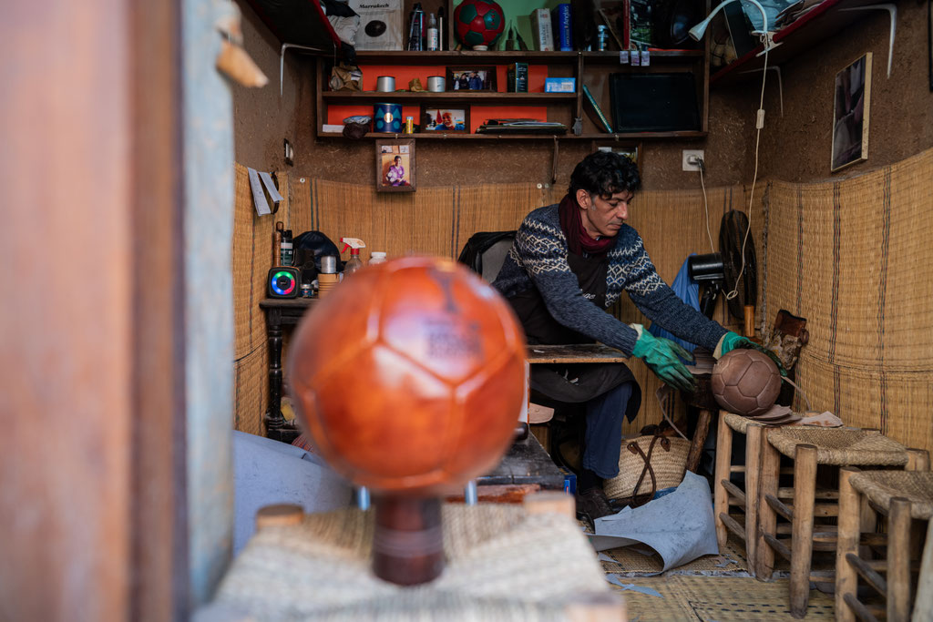 Kamal Boukentar handcrafting a football ball at La clinique du ballon - Marrakech Morocco