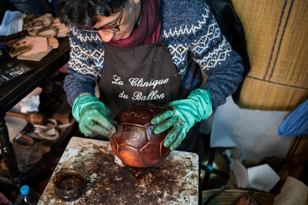 Kamal Boukentar handcrafting a football ball at La clinique du ballon - Marrakech Morocco