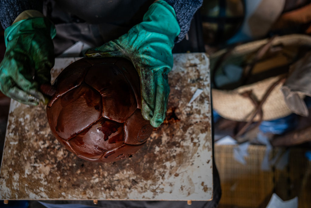 Kamal Boukentar handcrafting a football ball at La clinique du ballon - Marrakech Morocco
