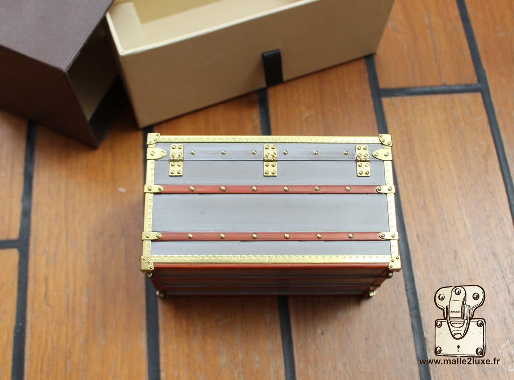 Collectible Louis Vuitton zinc Explorateur trunk miniature, perfect gift for vintage travel lovers.