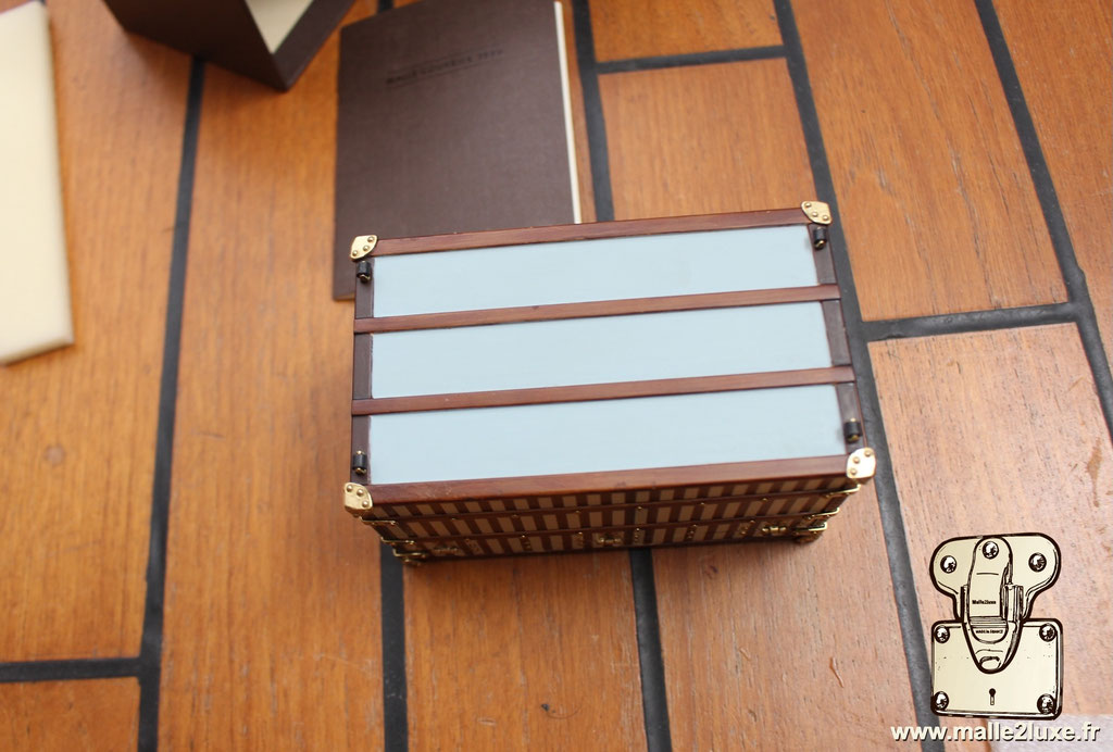Luxury collectible Louis Vuitton mini trunk replica, timeless design from the Maison’s historic 1888 archives.