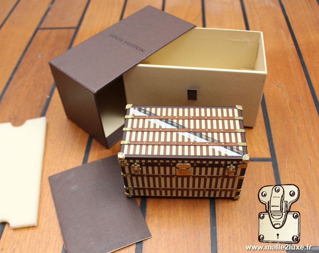 Close-up of Louis Vuitton striped mini trunk replica from 1888, beige and brown canvas, collector’s edition for display.
