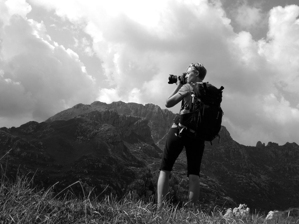 Black and white photograph of the photographer on the summit of Cima di Piazzo