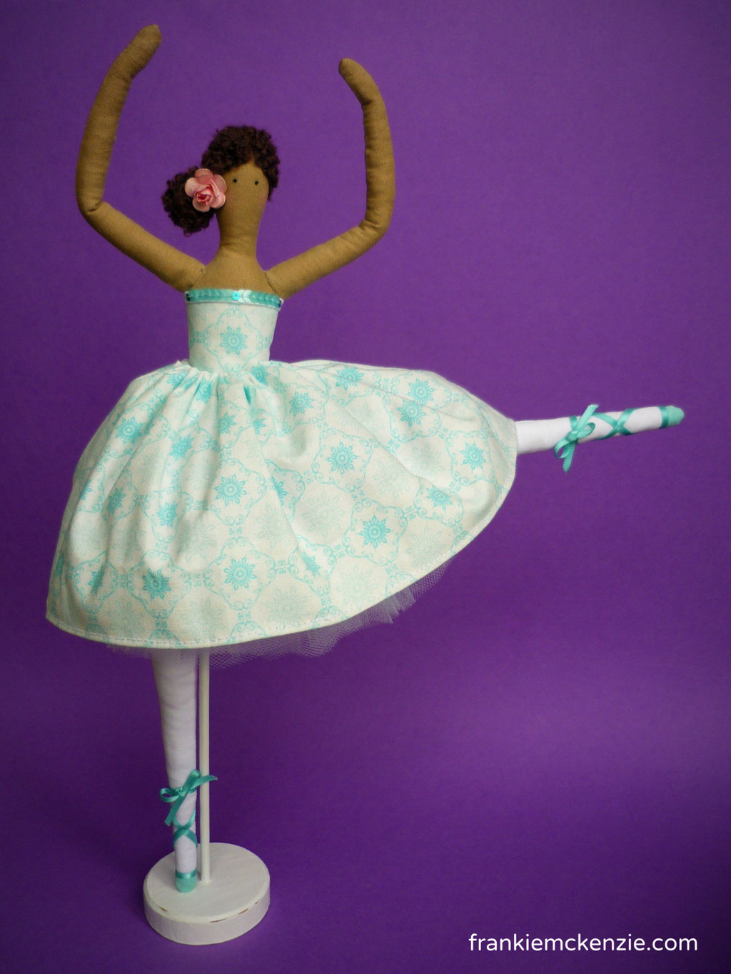 Little Ballerina Tilda doll wearing a white dress with turquoise floral elements