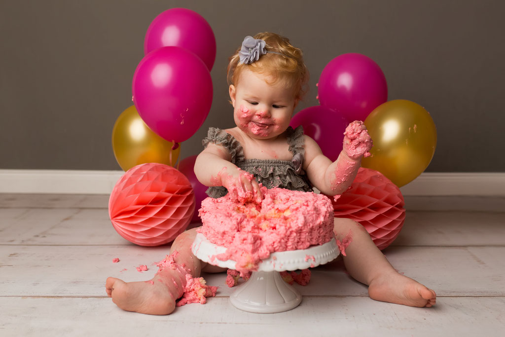 Der erste zaghafte Versuch – Baby berührt die Torte beim Cake Smash Fotoshooting