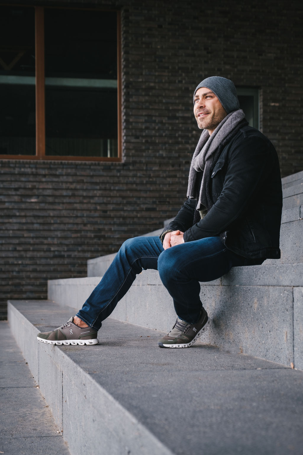 Urbanes Portrait mit männlichem Model sitzend auf Treppe.