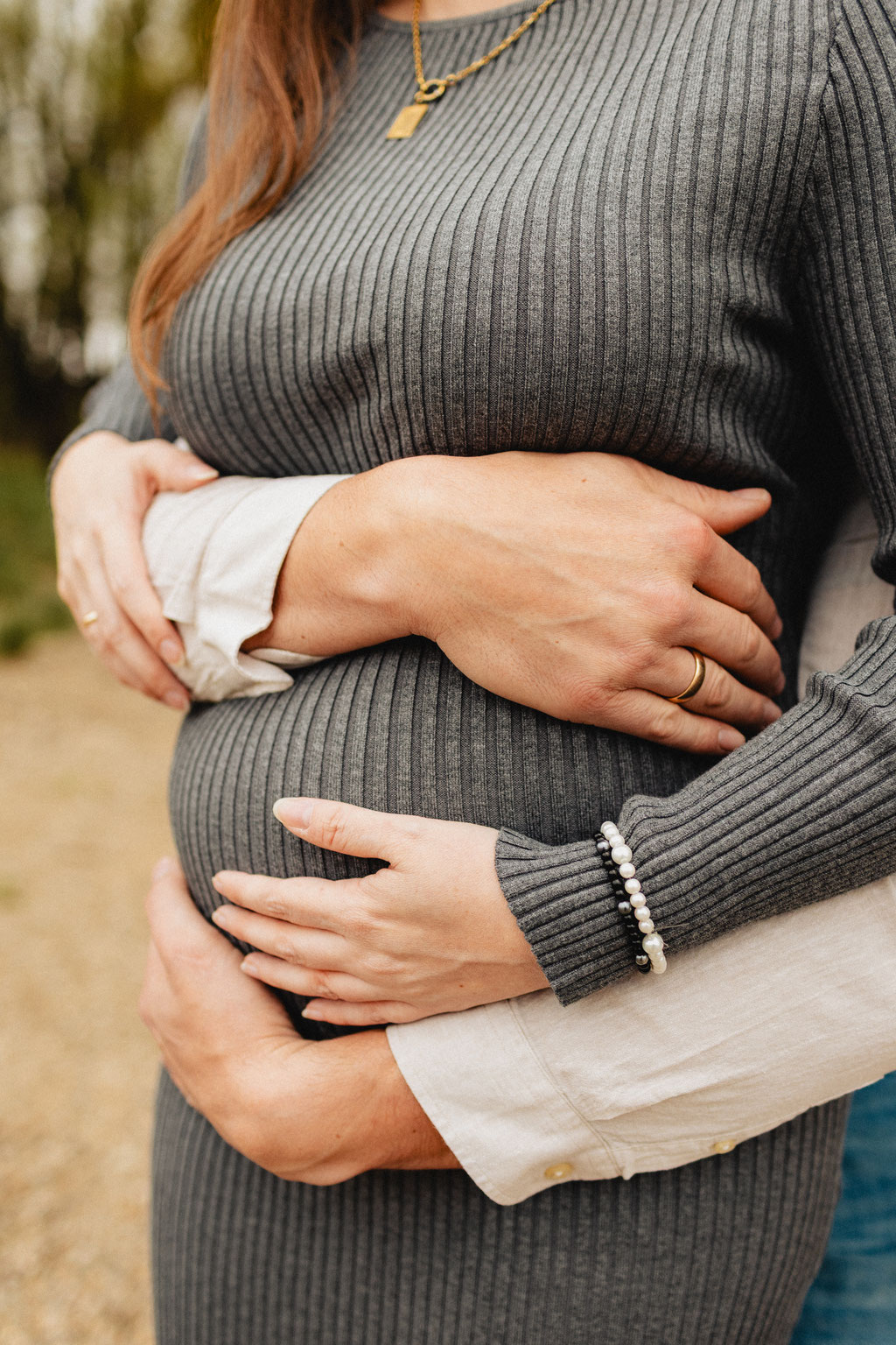 Detailbild mit Händen am Babybauch
