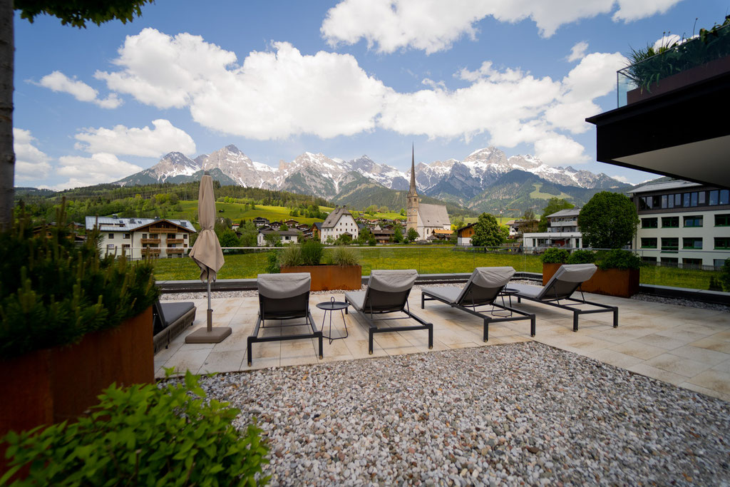Sun terrace at the Hochkönigin Wellness Hotel in Maria Alm, Salzburg, with views of the Hochkönig massif