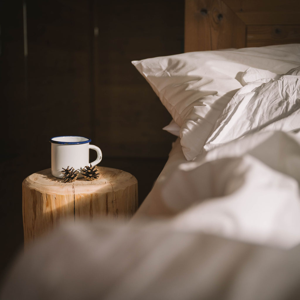Natural wood room at Hotel Tann on the Ritten plateau in South Tyrol with warm wooden elements and views of the surrounding nature.