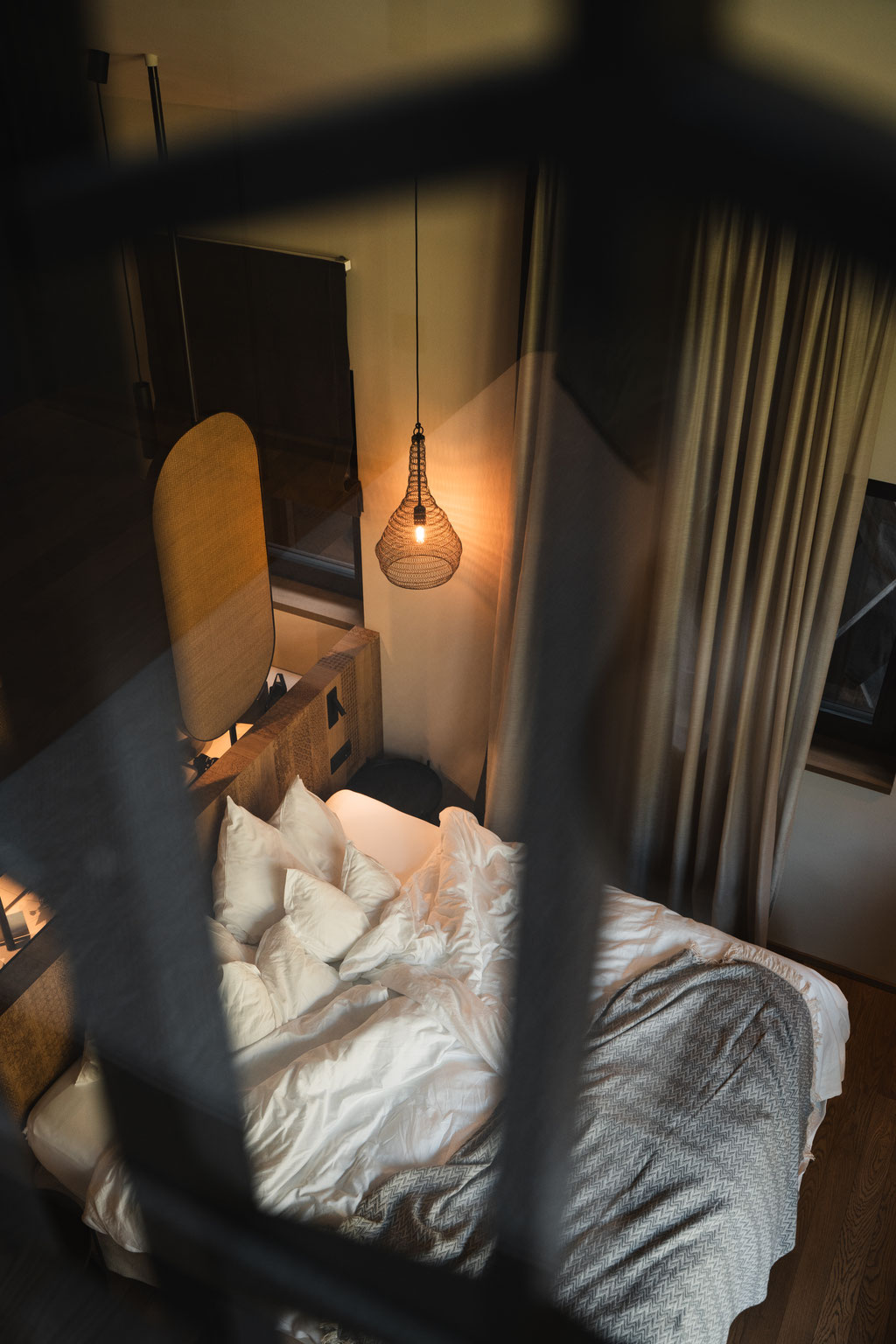 Gemütliches Schlafzimmer im Apfelhotel mit warmem Licht, hochwertigen Textilien und modernem Interior-Design.