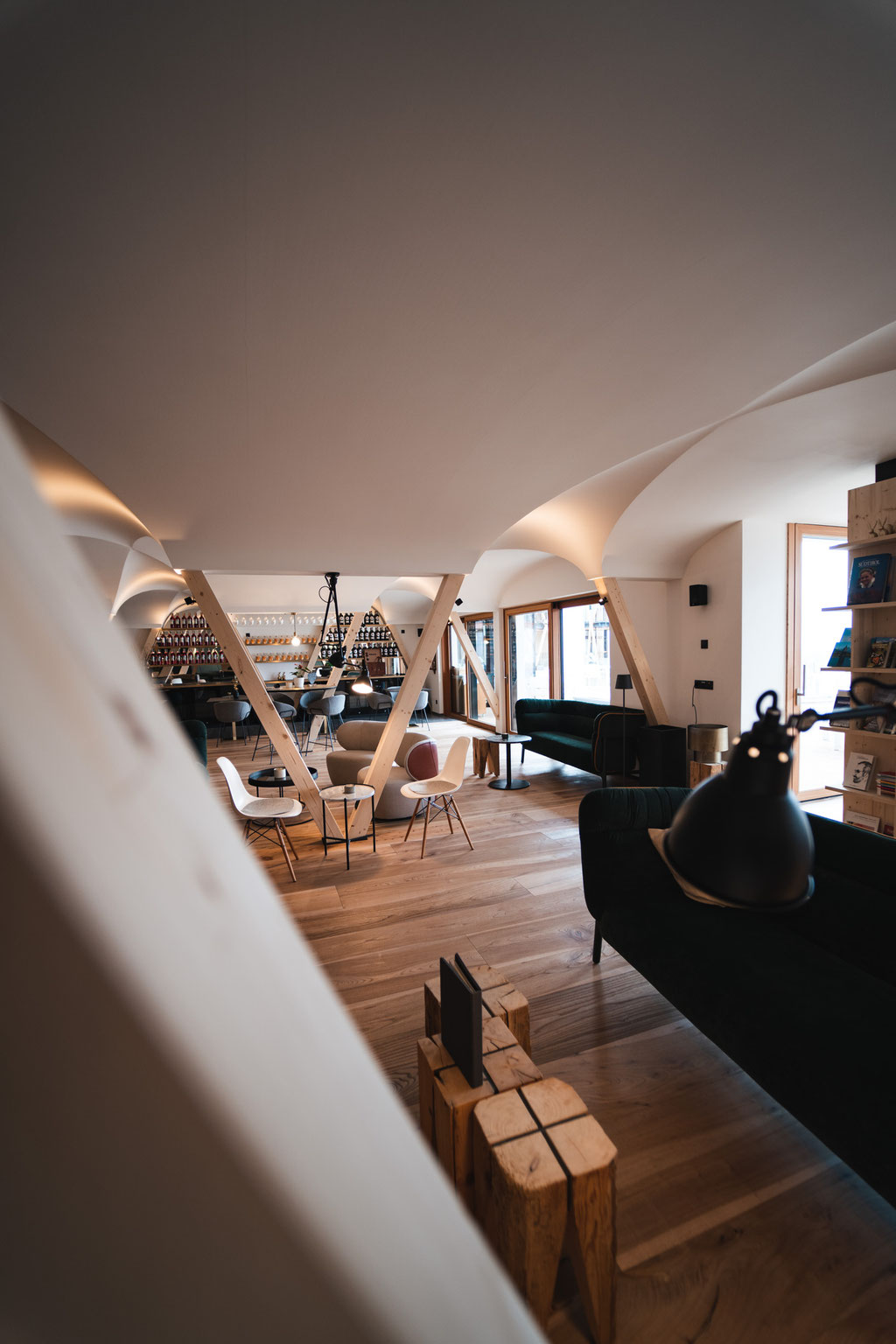 A modern lounge at the Garberhof featuring an open-plan layout, wooden features and a stylish bar.
