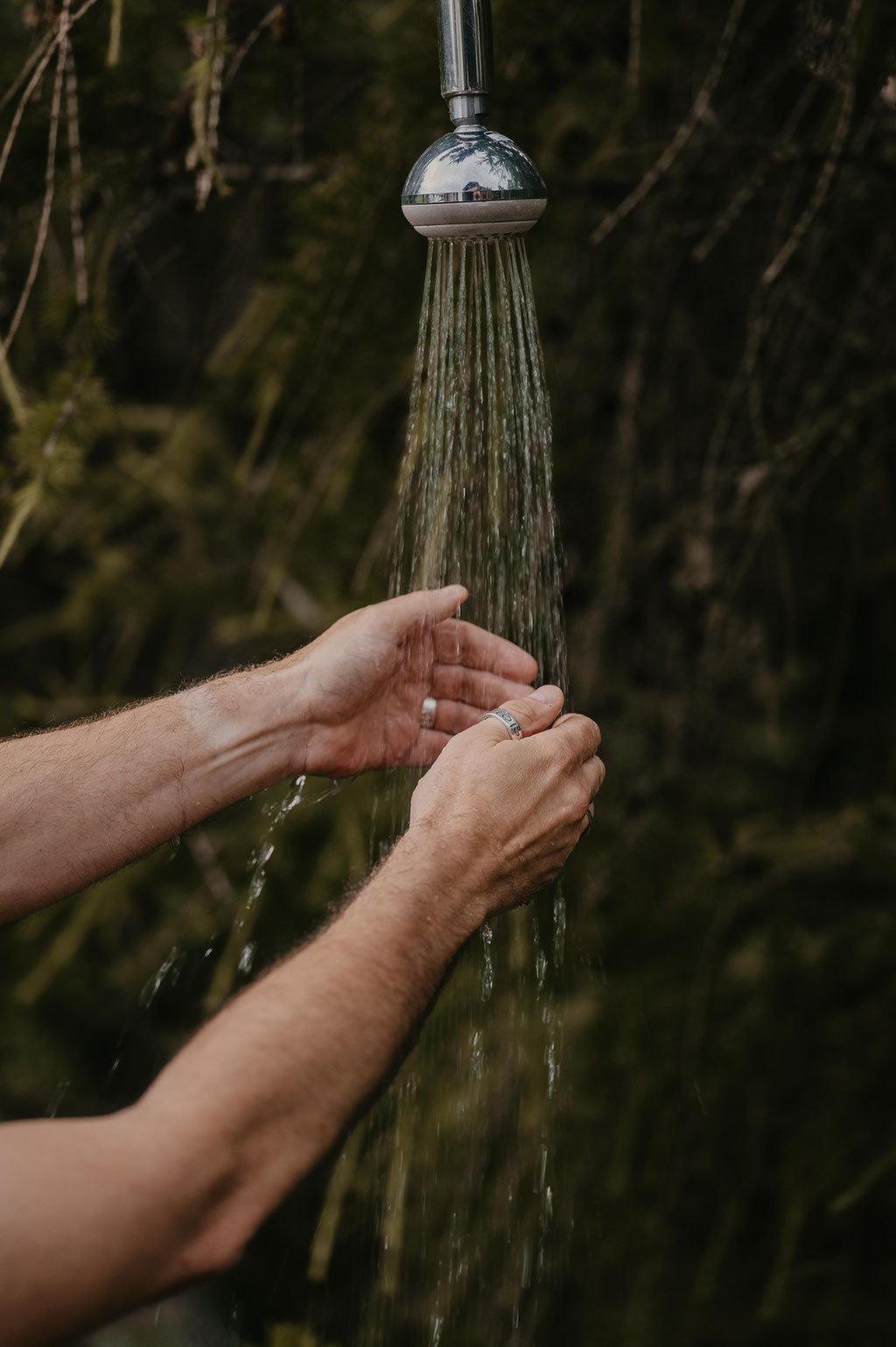 Outdoor forest shower in the woodland wellness area at Hotel Tann on the Ritten plateau in South Tyrol.