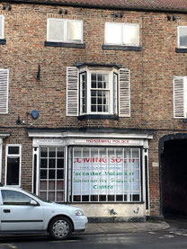 The new building with a coming soon sign in the bay window