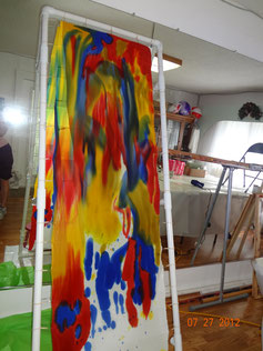 Example of a student's silk painting on a vertical frame, in progress