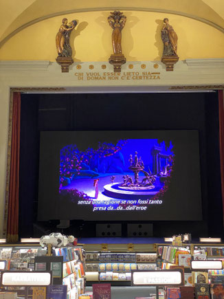 libreria in un cinema con cartone animato disney sottotitolato in inglese sullo schermo