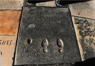 On January 25, 1950, John Wayne put his cowboy boots in the wet cement in front of Grauman's Chinese Theatre. An oddity: he did not print his hands but cast his fist.