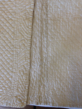 C18th quilted bedgown, showing centre back lining seam. BATMC 97.18 (loan)