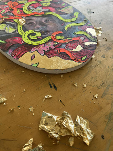 applying metal leafs on a canvas