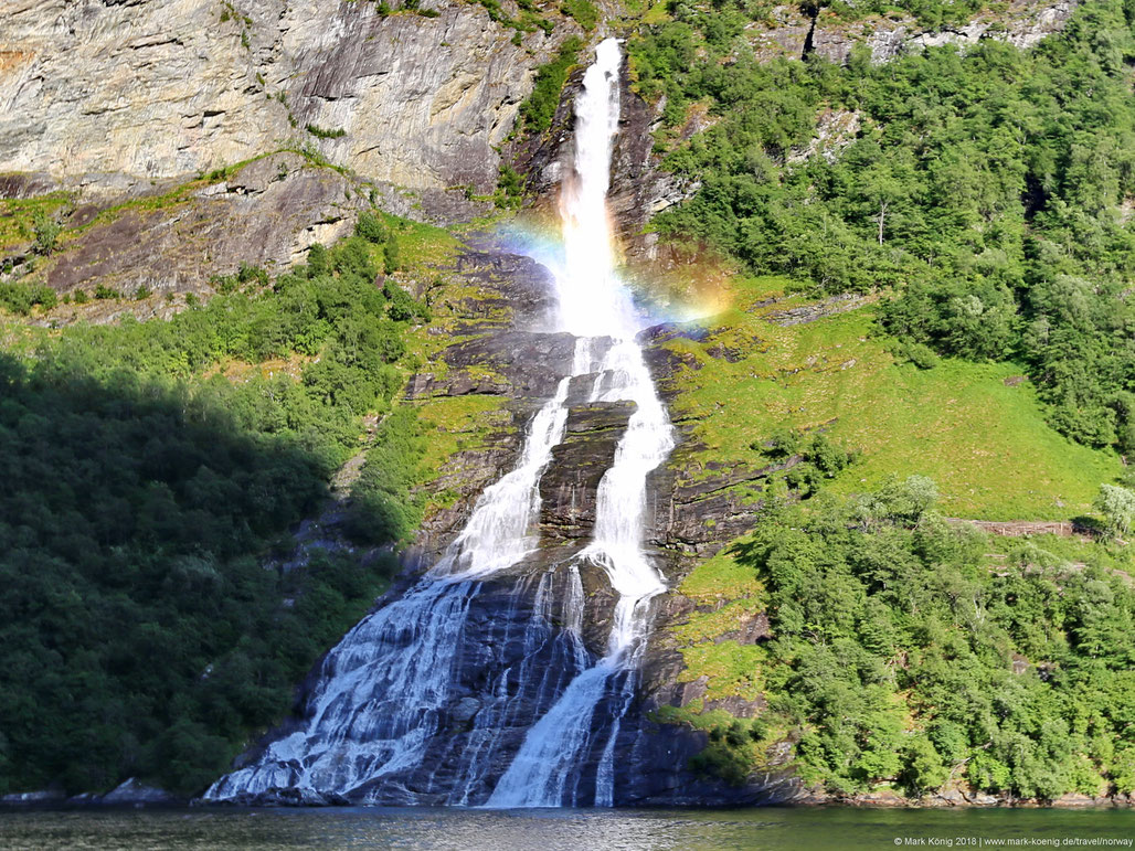 Waterfall Friaren shows the form of a bottle - small rainbow over the upper part of the waterfall