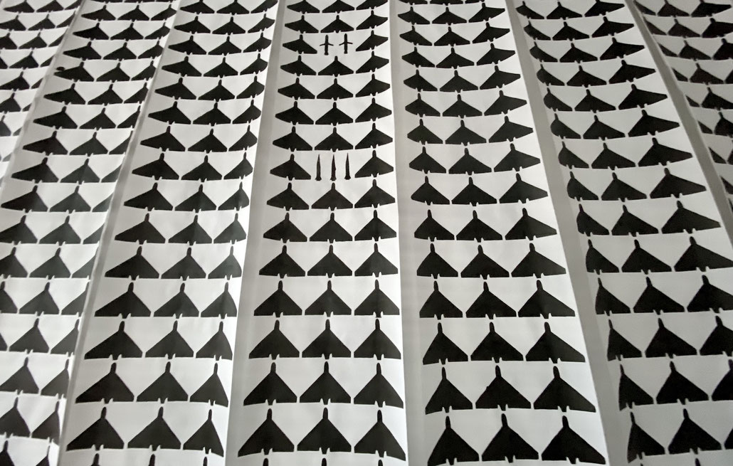Graphic art installation of hand-printed drone and missile silhouettes on paper, How I Spent My Summer by artist Olga Drozd