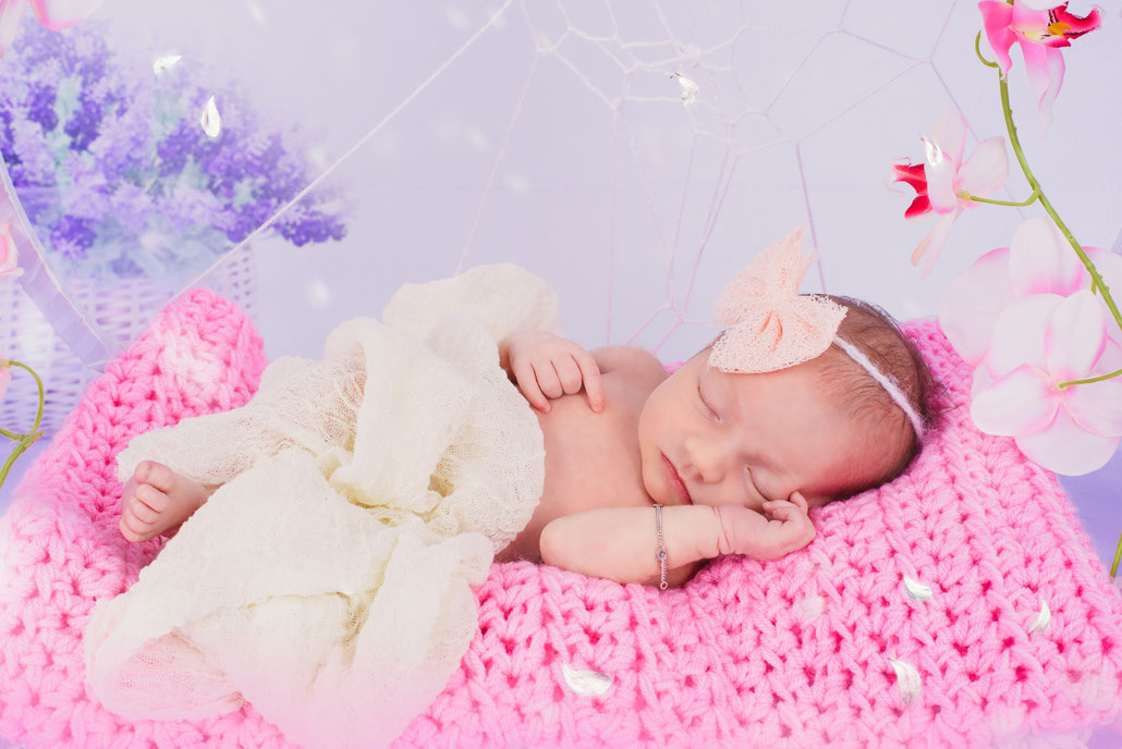 newborn on a pink fabric