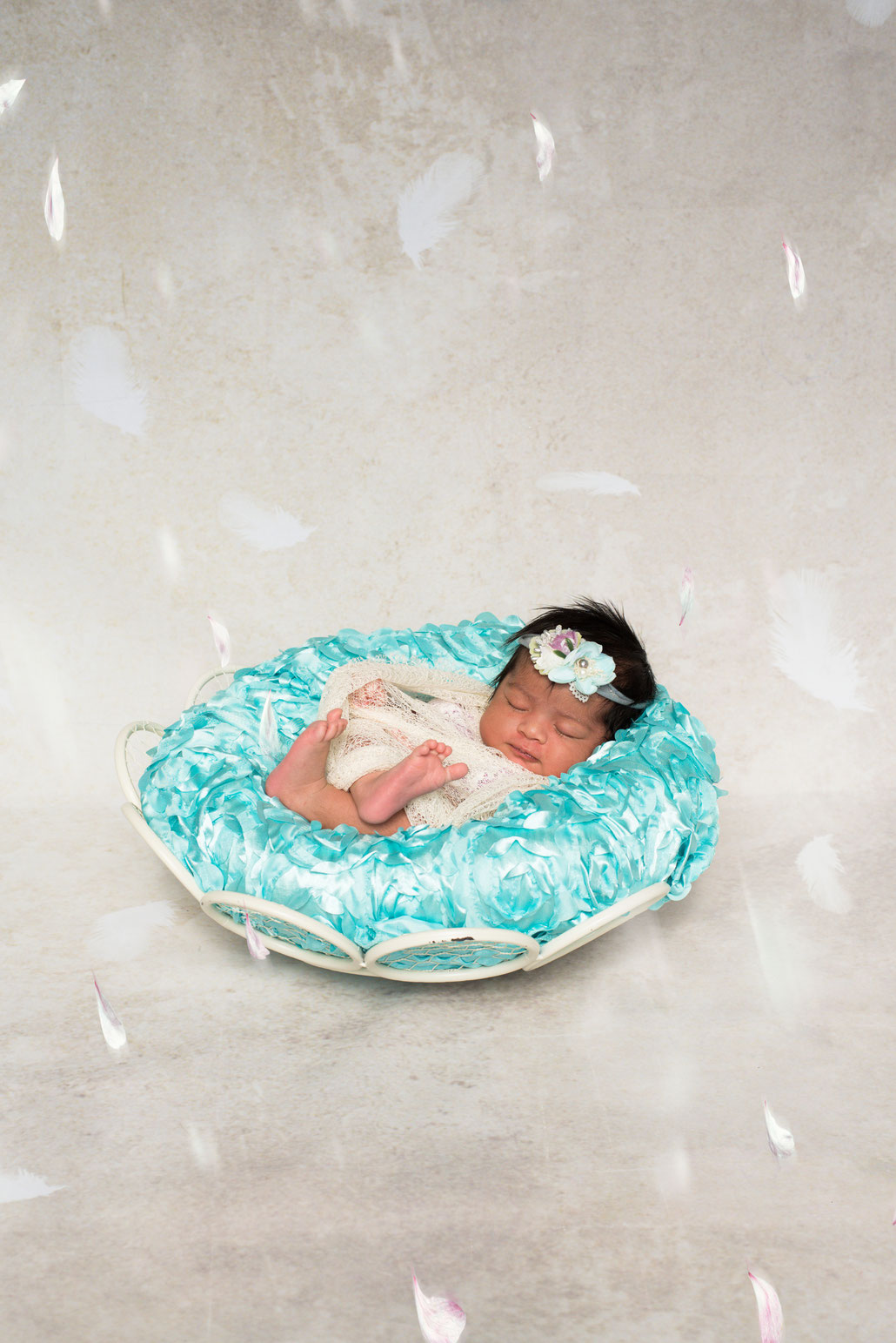 newborn on a blue pillow