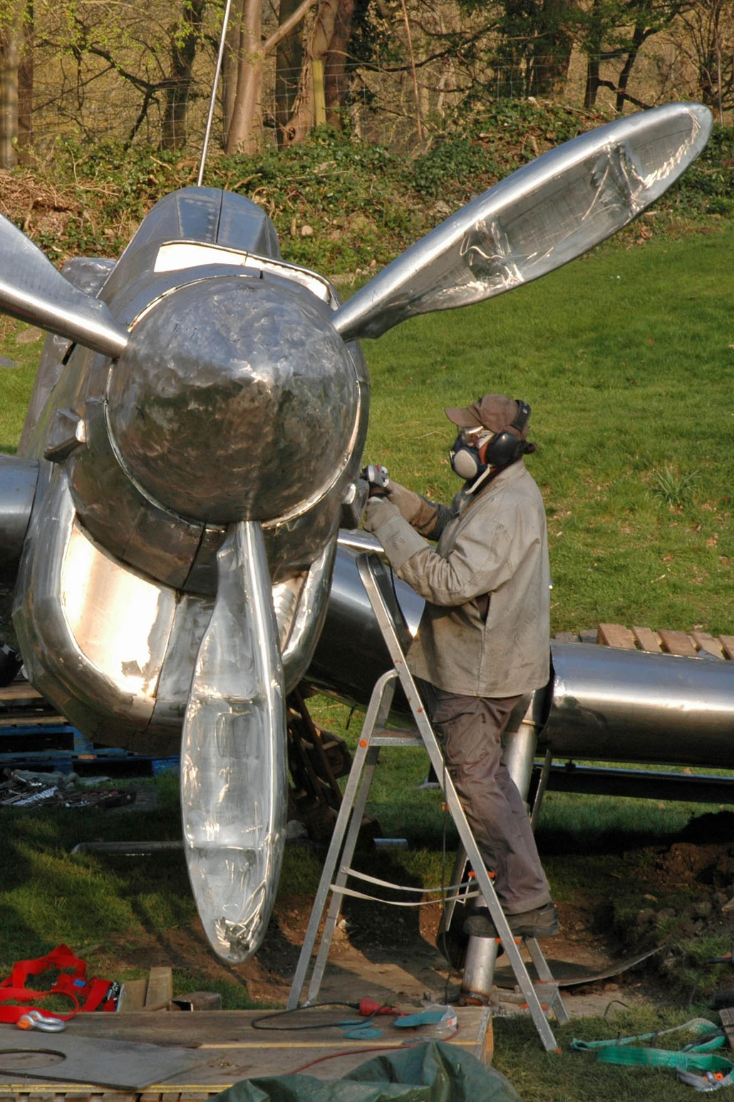 Sculptor HEX working at his STUKA sculpture at Burghley House Sculpture Park. This work is a memorial for the Battle of Britain. HEX is a Fellow of the Royal British Society of Sculptors.