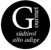 Logo von Gourmet Südtirol, ein schwarzer Kreis mit weissem großen G und den Wörtern: Gourmet Südtirol Alto Adige