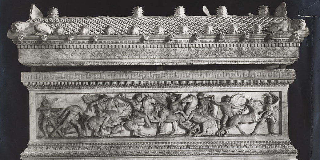 A marble sarcophagus with high-relief battle scenes and lion sculptures on the lid, featuring soldiers and horses in dynamic motion.