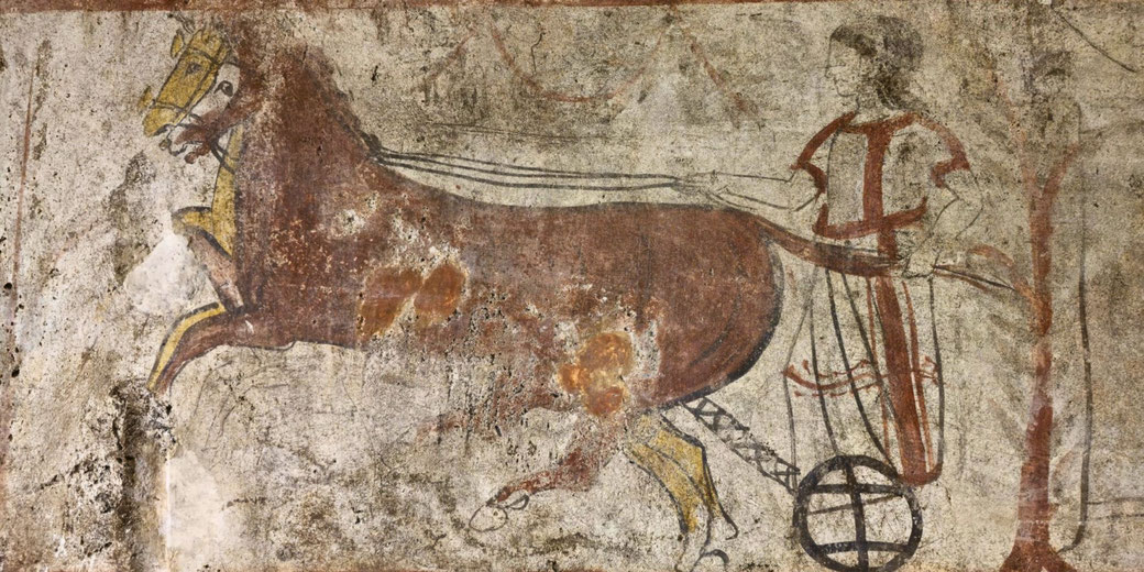 Ancient wall painting of a charioteer driving a two-wheeled cart pulled by a brown horse, with simple lines and faded earthy tones.