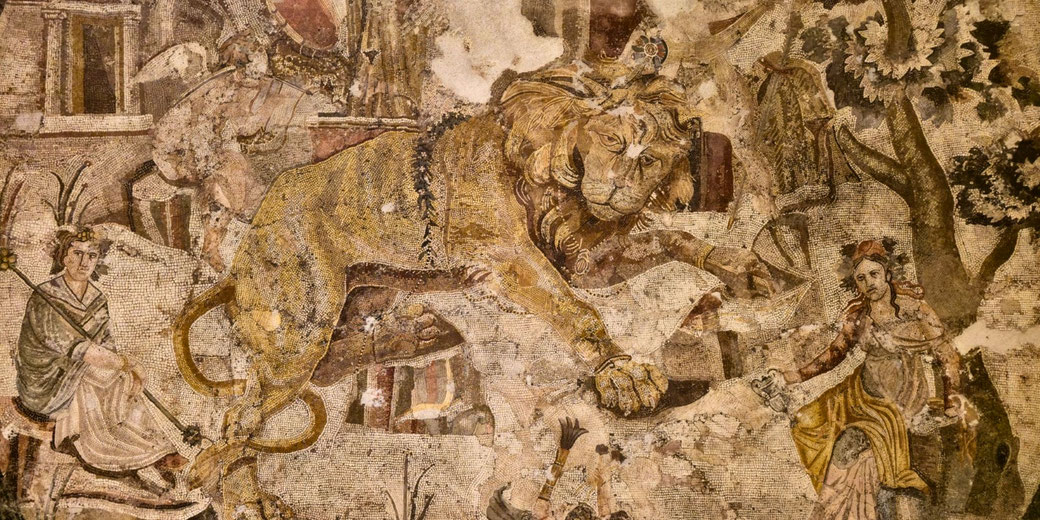 Ancient mosaic showing a regal lion in motion, surrounded by human figures and architectural elements in a vivid, detailed scene.