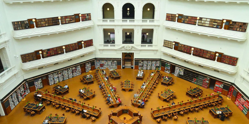 State Library of Victoria's La Trobe Reading Room in Melbourne, Australia. Its grand octagonal design, high bookshelves, and study desks create an iconic scholarly atmosphere.
