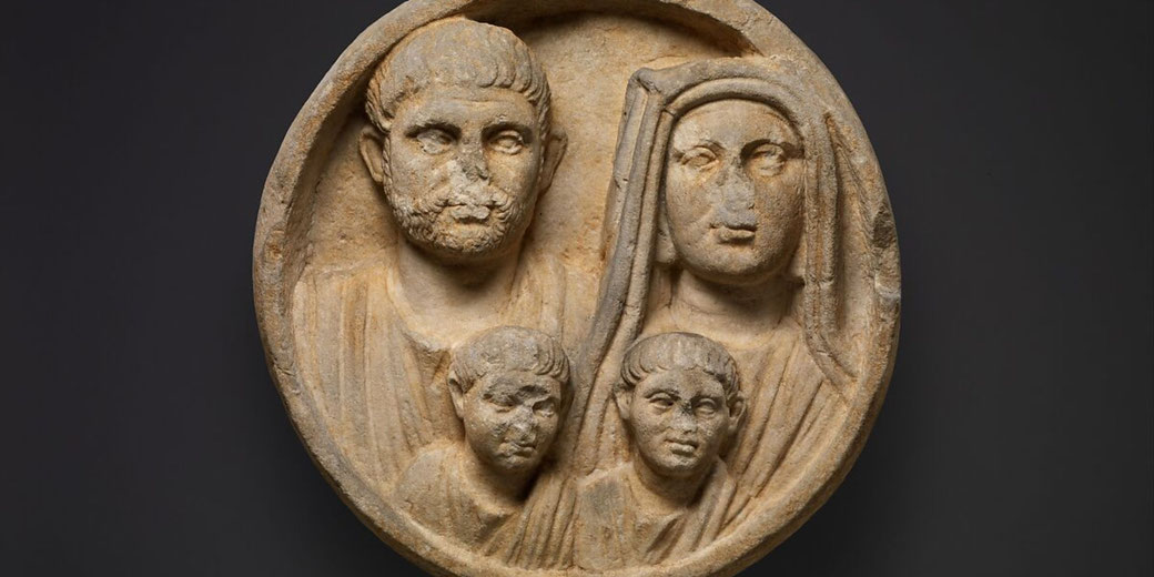 Circular marble relief depicting a Roman family, father, mother, and two sons, common in Thrace and Danube regions.