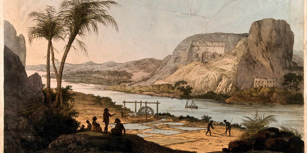River valley scene with palm trees, workers, and small boats; cliffs with carved temples rise above water under soft light, painted in a historic landscape style.