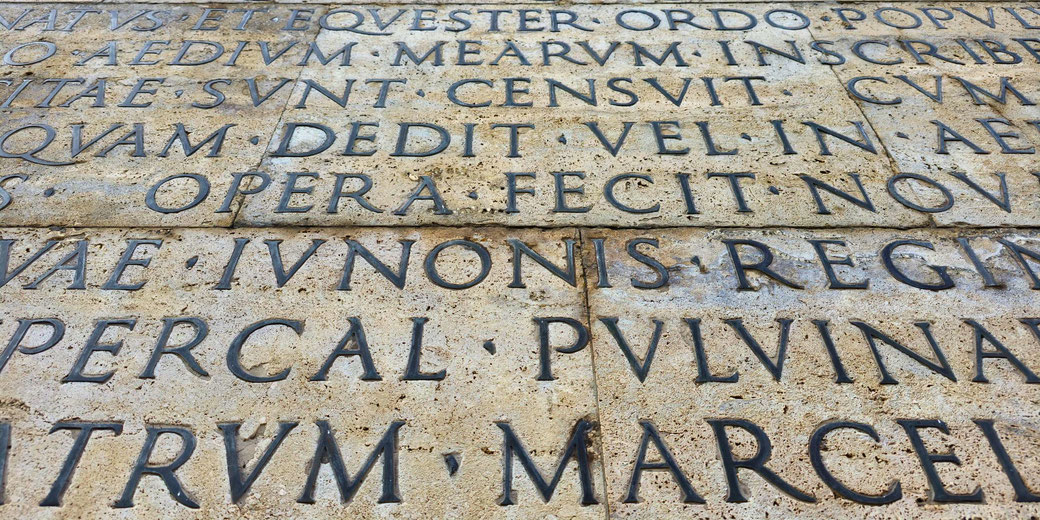 A close-up of the reconstructed Latin text of emperor Augustus' Res Gestae inscription at the Ara Pacis in Rome.
